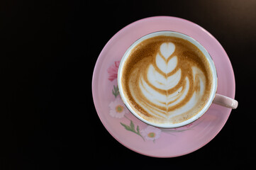 Latte art coffee cup on black background, Flat lay