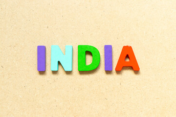 Color alphabet letter with word india on wood background