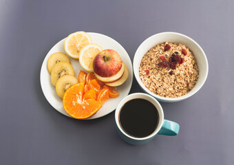 Mixed fruit dish,coffee cup and cereal bowl put on background,