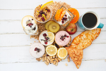 Yoghurt mixed fruit,bread,coffee cup put on wooden board,