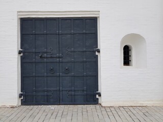 Iron wrought iron door in a stone wall