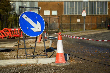 Road works. Orange traffic cones in the middle of the street.