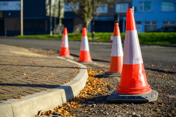 Road works. Orange traffic cones in the middle of the street.