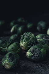 Fototapeta na wymiar Brussels sprouts cabbage on old wooden table.Dark mood food photography.