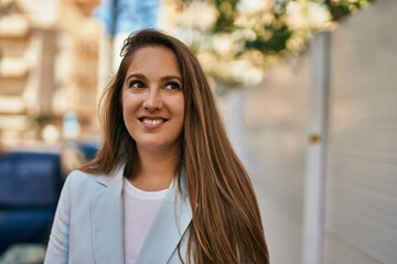 Fototapeta premium Young blonde businesswoman smiling happy standing at the city.