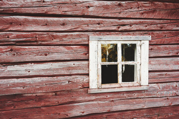 Naklejka na ściany i meble Window of abandoned log farmhouse at a summer farm up in the Totenåsen Hills, Norway.