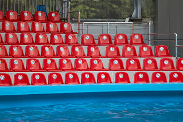 Empty, red bleachers before the performance in the pool