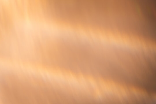Defocused glow overlay. Light flare. Holographic gleam leak. Bokeh radiance. Blur golden orange color gradient rays abstract background.