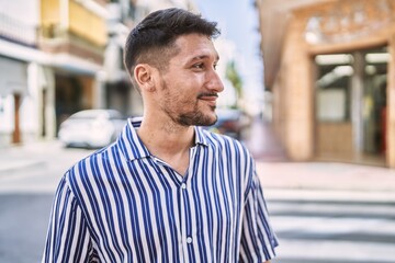 Young handsome man smiling confident at street