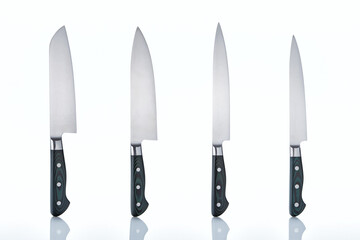 A set of professional Japanese kitchen knives from the finest steel on a white isolated background. A set of knives from a restaurant chef. The best tools for the kitchen and food preparation.