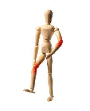 Joints ache concept. Wood doll person walking with pain in elbow and knee. Wood mannequin in motion, going.