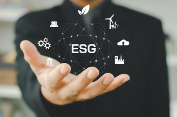 Environmental, social, and governance (ESG) investment Organizational growth that is sustainable is a business idea.  man's on icon  ESG word on hand a virtual screen.
