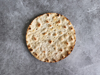 Round crispbread baked with wheat, barley and rye on gray background