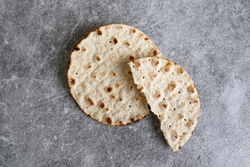 Round crispbread baked with wheat, barley and rye on gray background