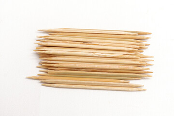 Pile of toothpicks on a white background. A tool for cleaning food residue on teeth.