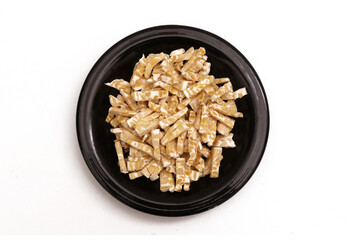 fermented soybeans that have been cut into small pieces on a black plate