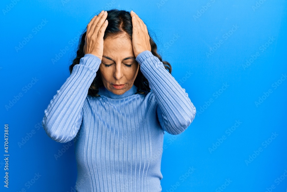 Poster Middle age hispanic woman wearing casual clothes suffering from headache desperate and stressed because pain and migraine. hands on head.