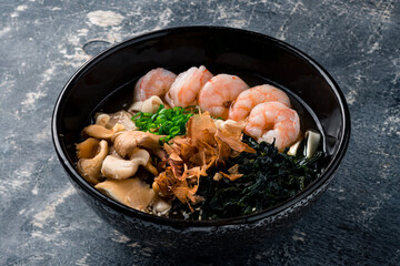 Spicy asian Ramen noodles with Prawns on dark background