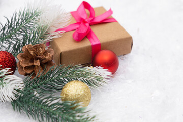 Christmas composition of Christmas tree toy red and gold ball snow present box background tree branch cone