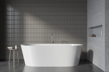 Naklejka na ściany i meble Grey bathroom interior with bathtub on black parquet floor, table with gels