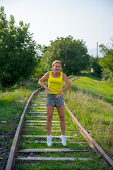 crazy girl jumping on the railroad tracks