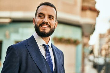 Fototapeta premium Young businessman smiling happy standing at the city.