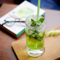 Lemonade(mojito) with mint and ice on a light and glasses background