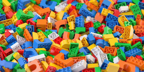 Fototapeta na wymiar Heap of colorful toy plastic bricks and blocks