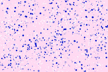 Blue and white circle confetti on pink background. New Year holiday card or banner backdriok. Transparent blue white polka dot round confetti on pink beautifulk background.