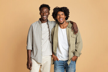 Male Friendship Concept. Two Happy Black Guys Embracing And Smiling At Camera