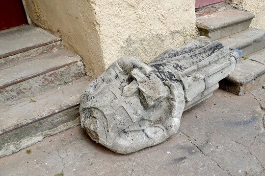 A sculpture of a headless knight of the Teutonic Order lies near the steps. Labiau Castle, XIII century. Polessk, Kaliningrad region