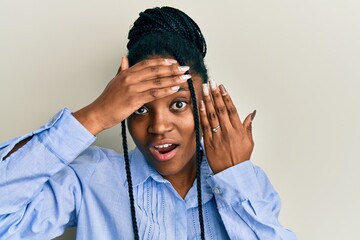 African american woman with braided hair wearing engagement ring stressed and frustrated with hand...