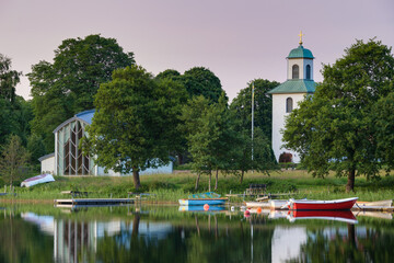 Boats on lake in front of church, Landvetter, Sweden