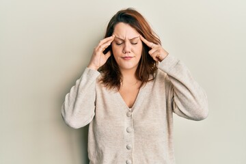 Young caucasian woman wearing casual clothes with hand on head, headache because stress. suffering migraine.