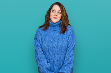 Fototapeta premium Young plus size woman wearing casual clothes smiling looking to the side and staring away thinking.