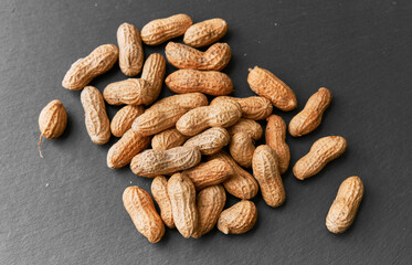 Obraz premium Image of bunch of peanuts on a slate surface