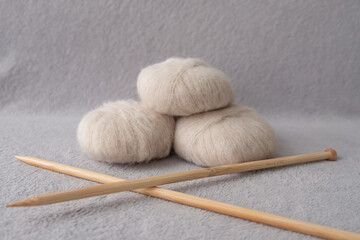 Three soft balls of alpaca silk yarn with two bamboo knitting needles