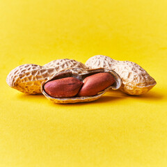  Middle peanut shell with peanuts on a yellow background