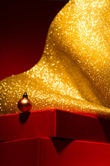 Red podium with gift boxes, gold Christmas decor Red background.