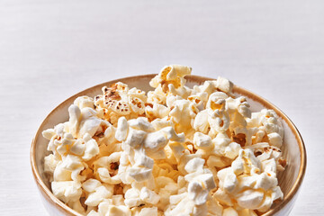  Bowl of salty popcorns isolated on a white background