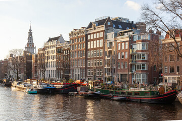 Canal in the old city of Amsterdam with traditional houseboats in a winter day, Netherlands.