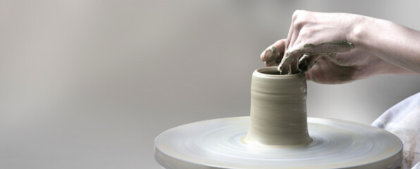  hands making ceramic cup - Powered by Adobe