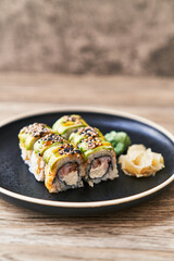  Plate of shrimp and cheese cream uramaki sushi on a wooden surface