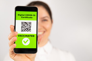 Woman showing smartphone with qr code about vaccination.