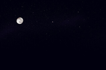Huge full moon on the night blue star sky.
