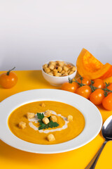 Vegetarian pumpkin soup. Seasonal autumn food - orange pumpkin soup with croutons.