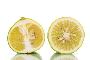 Two halves of fragrant ripe bergamot, close-up, isolated on white.