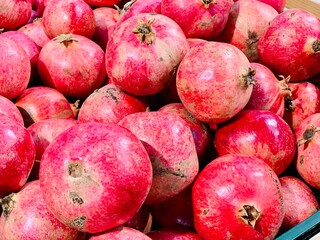 Lots of red pomegranates close-up.