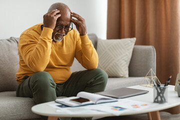 Senior African American Man Touching Head Having Problem At Home