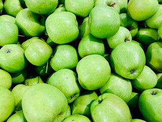Lots of green apples close-up.